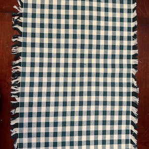Set of six cotton fringed placemats and six cotton fringed napkins, in green and white plaid for casual indoor/outdoor dining or picnicking.
