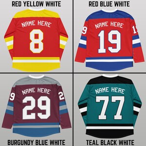 May include: Four different hockey jerseys with different color combinations. The jerseys are red with yellow and white stripes, red with blue and white stripes, burgundy with blue and white stripes, and teal with black and white stripes. Each jersey has a white number on the back with the text "NAME HERE" above the number.