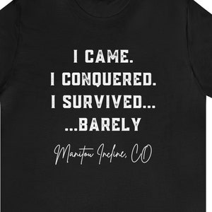 May include: Black t-shirt with white text that reads "I CAME. I CONQUERED. I SURVIVED... ...BARELY Manitou Incline, CO"