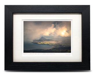 May include: A framed photograph of a scenic view of a bay and a mountain in the distance. The sky is cloudy and the sun is shining through the clouds. The caption below the image reads "BARDONICK & BARDONICK BAY, ISLE OF ARRAN FROM GAIRTEILL".