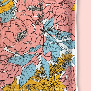 May include: A white background with a pink, yellow, and blue floral pattern. The flowers are outlined in black and have a textured appearance.