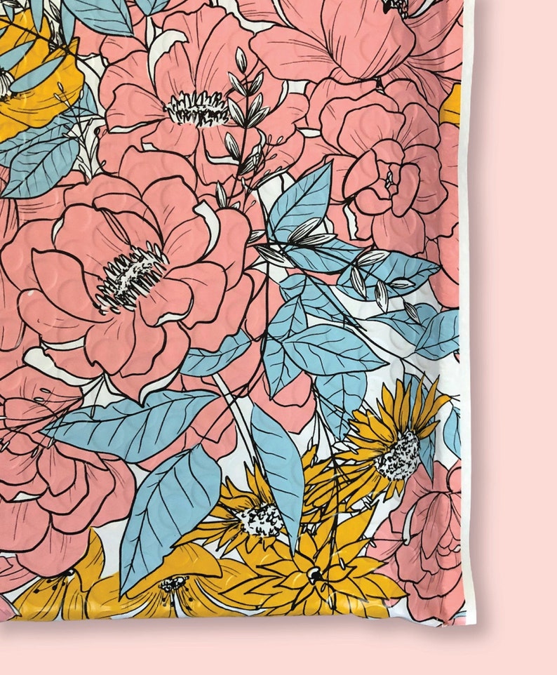 May include: A white background with a pink, yellow, and blue floral pattern. The flowers are outlined in black and have a textured appearance.
