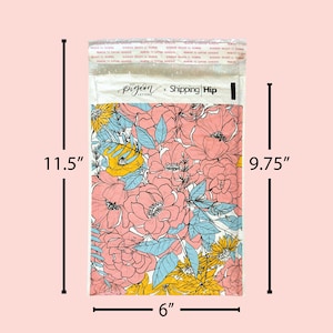May include: A pink and blue floral patterned mailing envelope with the text "Pigeon Letters x Shipping Hip" printed on the front. The envelope measures 11.5 inches by 9.75 inches and 6 inches wide.