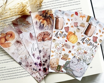 May include: Set of five autumn-themed bookmarks featuring watercolor illustrations of animals, leaves, and fall-inspired objects. The bookmarks include a deer, a fox, a cat, a dog, and a cup of coffee. The text "Autumn" and "October" are featured on the bookmarks.