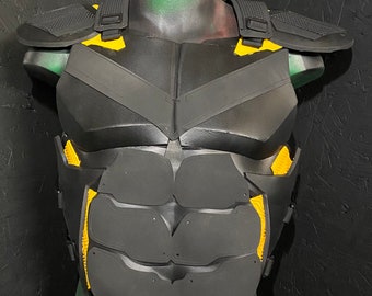 May include: Black and yellow chest armor with shoulder pads, displayed on a mannequin. The armor features a segmented design with yellow accents and straps. The overall aesthetic suggests a futuristic or tactical theme.