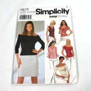 May include: Simplicity sewing pattern 5875 for sizes P5 12, 14, 16, 18, 20. The envelope features illustrations of various tops and a skirt, including an off-the-shoulder black top, a pink top with flared sleeves, and a white top with shoulder ties.