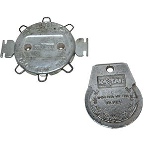 May include: Two silver spark plug gap tools. One is round with multiple prongs and measurements. The other is a wedge shape with a gauge and the text "Spark Plug Gap Tool Inches". Both tools have the "Kastar" logo.