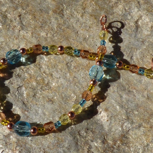 7.5" flexible wire beaded bracelet with light aqua, jonquil yellow, peach and copper metal and glass beads and copper clasp
