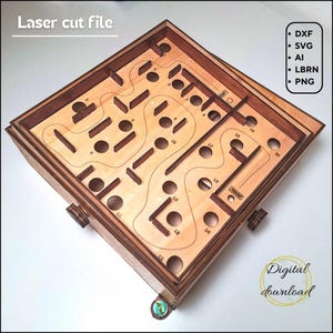 May include: Wooden laser-cut maze game with a light brown interior and a darker brown frame. The game features a series of numbered holes and pathways. The text "Laser cut file" and "Digital download" are visible.