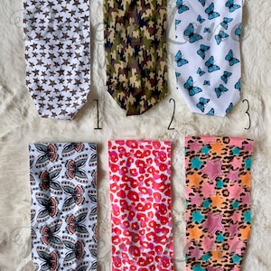 May include: Six different fabric headbands with various patterns. The headbands are white with brown stars, camouflage, blue butterflies, colorful butterflies, red and white leopard print, and pink and orange stars.