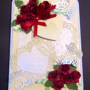 Romantic oldfashioned vintage style Valentine's Day card, lace hearts, roses, ribbon and pearls.