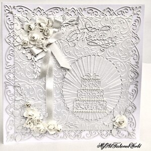 Romantic old fashioned vintage style luxury white on white card for wedding featuring wedding cake, pearls, lace and roses.