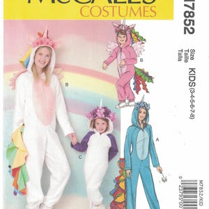 May include: McCall's Costumes M7852 sewing pattern for kids sizes 3-8. The envelope features illustrations of three unicorn-themed jumpsuits with hoods, horns, and colorful tails. One is white with a pink belly, one is pink, and one is blue.