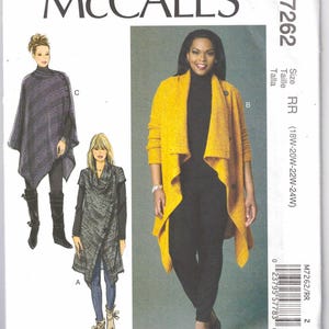 May include: McCall's M7262 sewing pattern featuring three different women's garment designs. The pattern includes illustrations of a gray poncho, a gray wrap, and a yellow cardigan. The size range is 18W-24W.