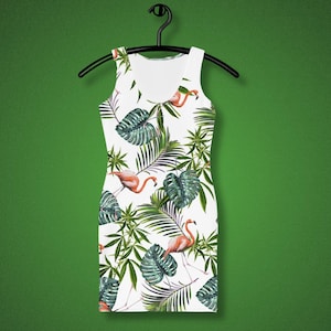 May include: White sleeveless dress with a tropical print featuring pink flamingos and green palm leaves.