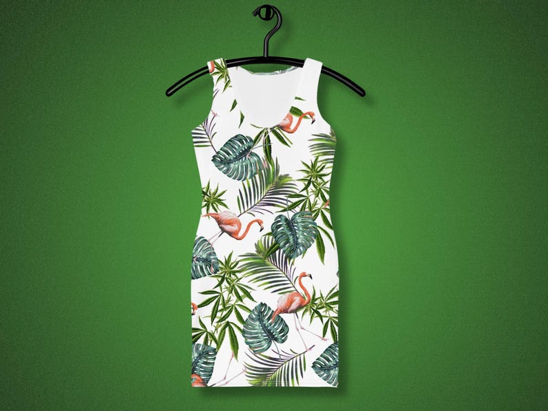 May include: White sleeveless dress with a tropical print featuring pink flamingos and green palm leaves.