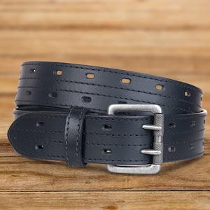 May include: A black leather belt with a silver buckle and a stitched design. The belt has multiple rows of stitching and a series of evenly spaced holes.