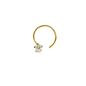 May include: A gold nose ring with a single clear diamond.