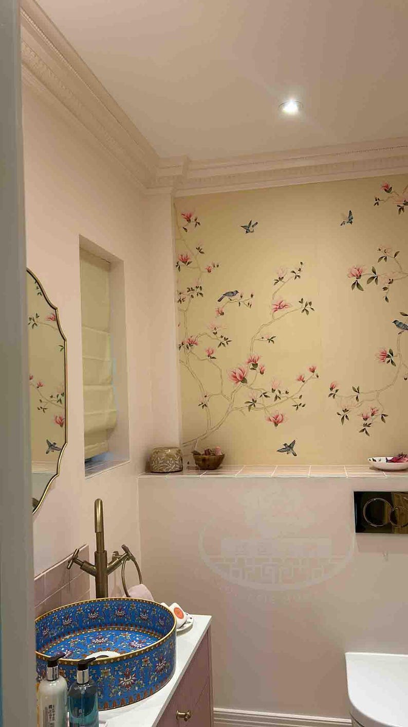 Elegant powder room with chinoiserie hand-painted magnolia mural in pink and ivory tones