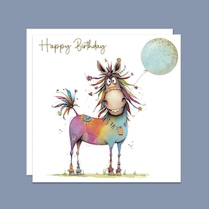 May include: A colourful birthday card featuring a whimsical horse with a rainbow mane and tail, holding a blue balloon. The card says "Happy Birthday" in gold lettering.