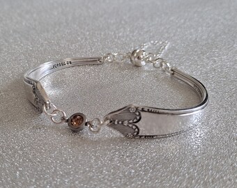 Vintage cutlery bracelet with an orange diamanté connector, safety chain and magnetic clasp.