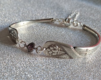 Vintage cutlery bracelet with a pink diamanté connector, safety chain and magnetic clasp.