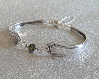 Vintage cutlery bracelet with a green diamanté connector, safety chain and magnetic clasp.