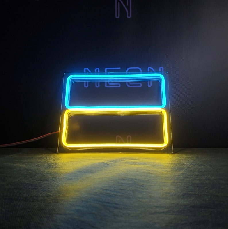May include: A neon sign with a blue and yellow design. The sign is in the shape of a rectangle and has the word "NEON" written on it.