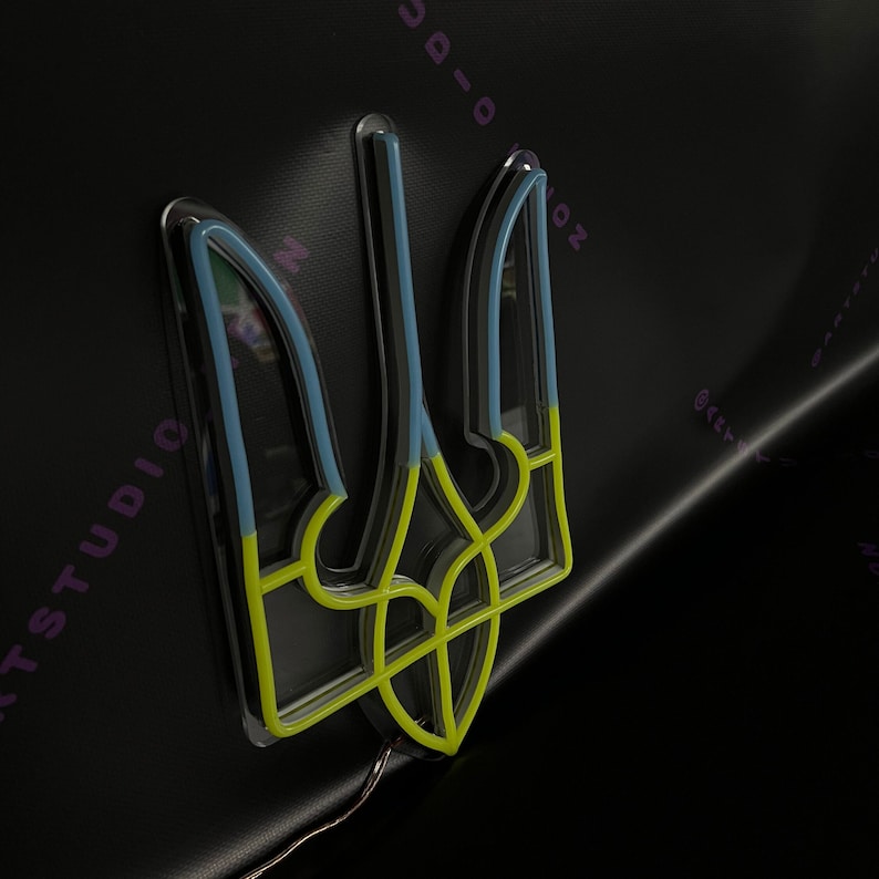 May include: A yellow, blue, and white neon sign of the Ukrainian trident, a traditional symbol of Ukraine.