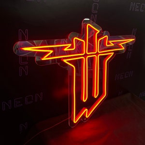 May include: A neon sign in the shape of a stylized cross with a lightning bolt design, illuminated in bright red. The sign is mounted on a clear acrylic backing, with the word "NEON" visible in the background.