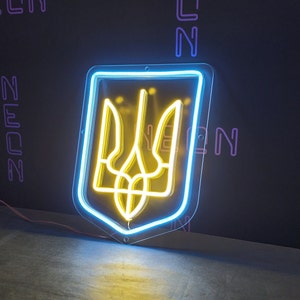 May include: A neon sign depicting the Ukrainian coat of arms, a yellow trident, inside a blue outline. The sign is mounted on a black wall.