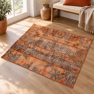 May include: A rectangular area rug featuring a distressed, faded pattern in shades of burnt orange, rust, and charcoal grey. The design consists of horizontal bands with intricate, weathered floral and geometric motifs across the entire surface.