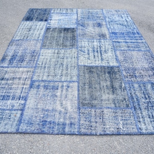 May include: A white ceramic mug with a black handle and the text "But First, Coffee" in a black, handwritten-style font. The mug is on a white surface.