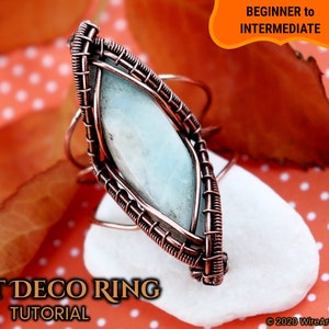 May include: A copper wire wrapped ring with a light blue gemstone. The ring is on a white rock with a red background. The text "ART DECO RING TUTORIAL" is at the bottom of the image. The text "BEGINNER to INTERMEDIATE" is at the top of the image.