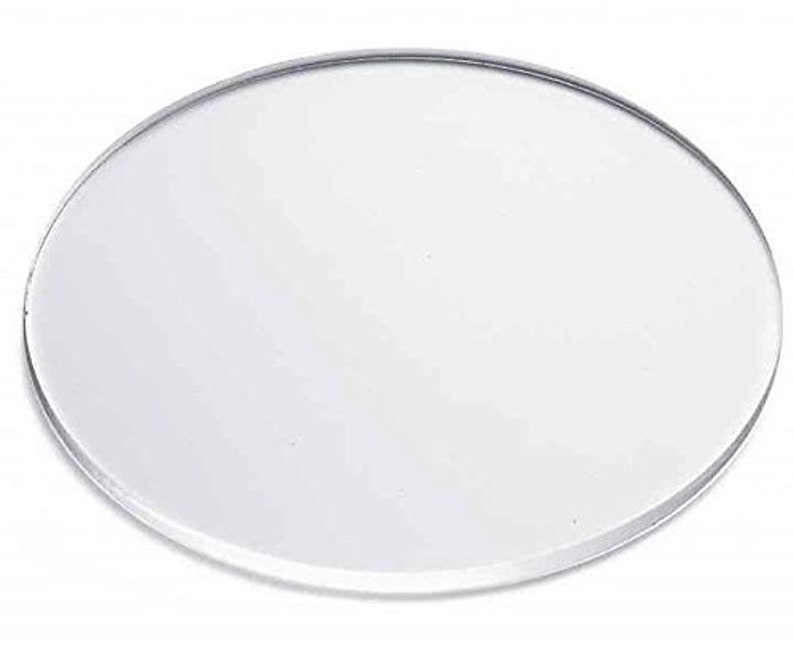 May include: A clear, round, acrylic coaster. The coaster is smooth and has a slightly raised edge.