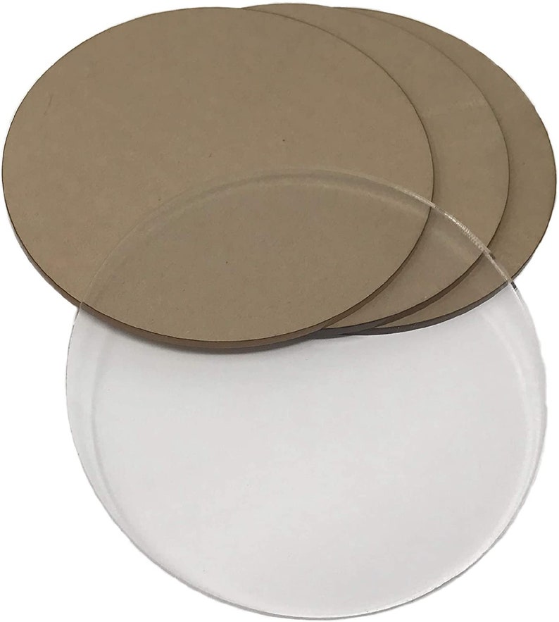 May include: Four brown round wooden discs stacked on top of each other. A clear round acrylic disc is underneath the wooden discs.