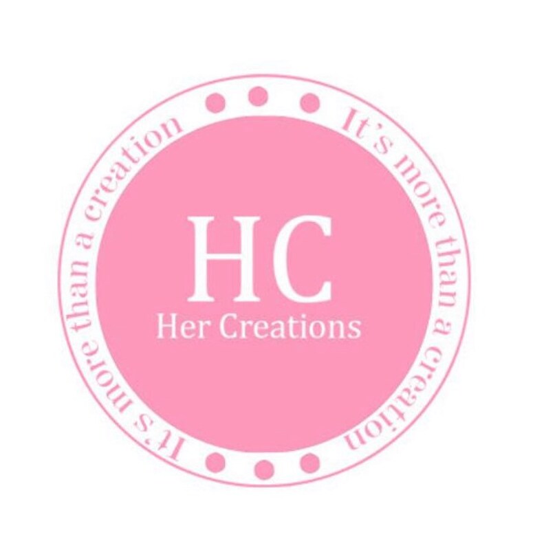 May include: A pink circle with white text that reads "It's more than a creation" and "It's more than a creation" in a circular pattern. The text "HC Her Creations" is in the center of the circle.