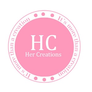May include: Pink circle with white text that reads "It's more than a creation" and "HC Her Creations".