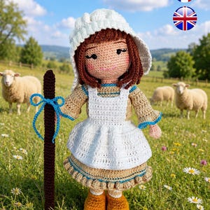 May include: A handcrafted crochet doll featuring brown yarn hair, a white bonnet, and a tan dress with a white apron. The doll wears yellow shoes and holds a dark brown staff decorated with a bright blue ribbon tied in a bow at the top.