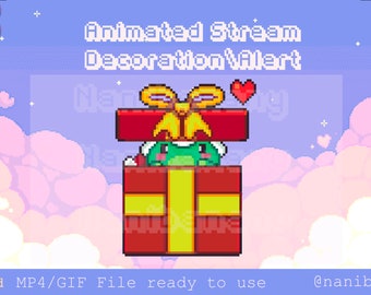 May include: Animated stream alert decoration featuring a green frog peeking out of a red and yellow gift box with a yellow bow. The background is a pastel blue with pink clouds.