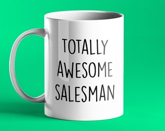 May include: White ceramic coffee mug with black text that reads "Totally Awesome Salesman".