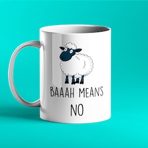 May include: White ceramic mug with a cartoon sheep with black eyes and hooves. The mug has the text "BAAAH MEANS NO" printed on it.