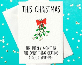 May include: A white Christmas card with a red bow and green mistletoe. The text on the card reads "This Christmas the turkey won't be the only thing getting a good stuffing!"