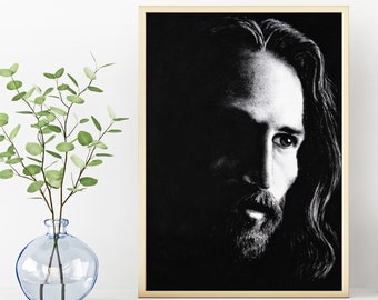 May include: Black and white portrait of a man with long hair and a beard. The image is framed in a light wood frame.