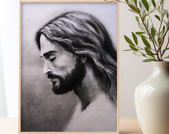 May include: A framed black and white charcoal drawing of a man with long hair and a beard, looking down with his eyes closed.
