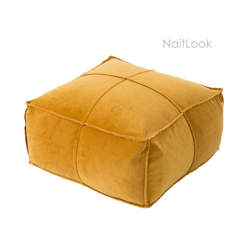 May include: A mustard yellow velvet square ottoman with a tufted design. The ottoman has a simple, modern design.