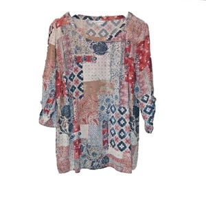 May include: A patchwork top with a round neck and three-quarter sleeves. The top features a mix of patterns in red, blue, beige, and white. The sleeves are gathered at the elbow. The overall style is casual and bohemian.