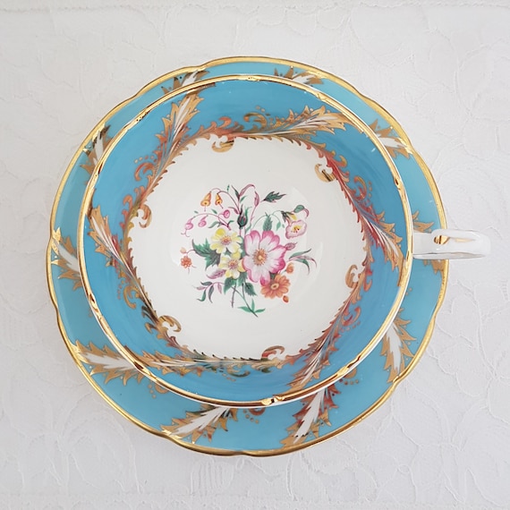 Paragon Bone China Tea Cup and Saucer: Floral Center, Gold Feather Detail