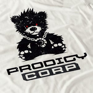 May include: White t-shirt featuring a distressed black bear graphic with red eyes and a chain necklace. The text "PRODIGY CORP" is printed in a bold, blocky font below the bear illustration.