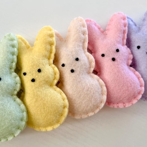 Pastel colored felt bunnies with puffy tail on back